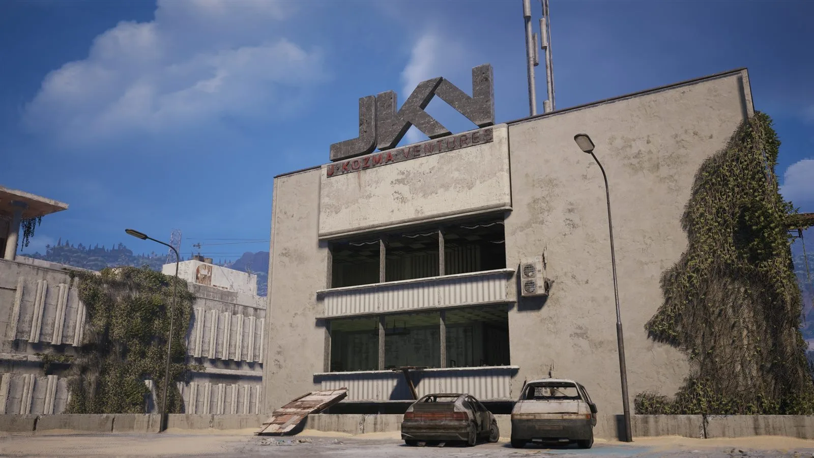 The exterior of the J Kozma Ventures Space Travel building in Buried City, half buried in sand
