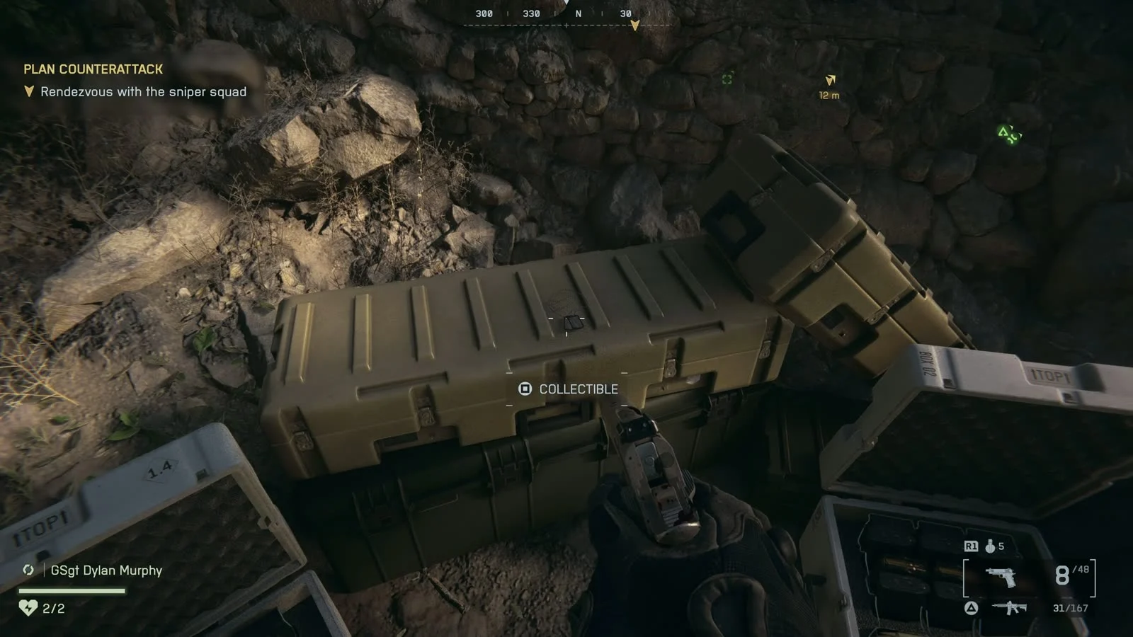 First-person view of a hand pointing a pistol at an olive-green equipment crate with a small dog tag on its lid and a Collectible prompt, during the Always Faithful objective Rendezvous with the sniper squad