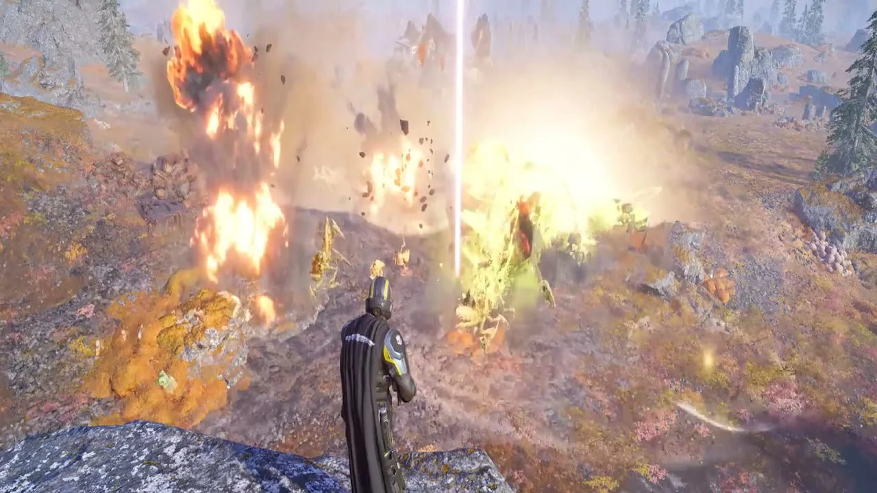 A Helldiver on a ridge watching an Eagle Airstrike's line of explosions land on a group of Terminid bugs