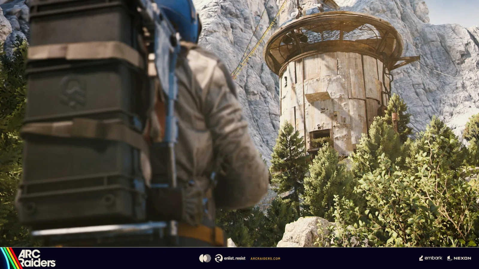 A Raider looking up at the round Outpost tower on a rocky mountainside in ARC Raiders