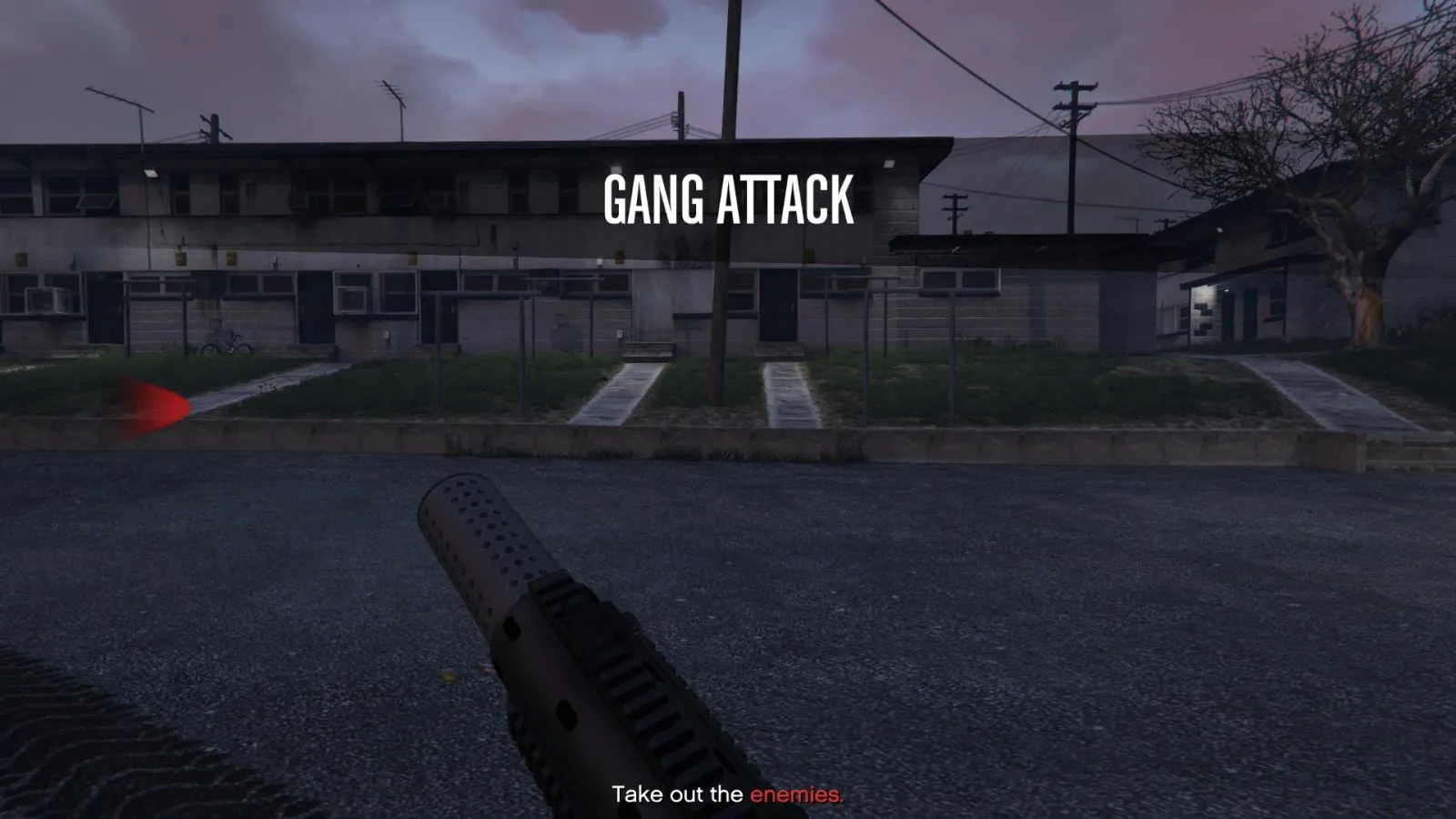 GTA Online Gang Attack start screen at a run-down apartment block, with the objective Take out the enemies