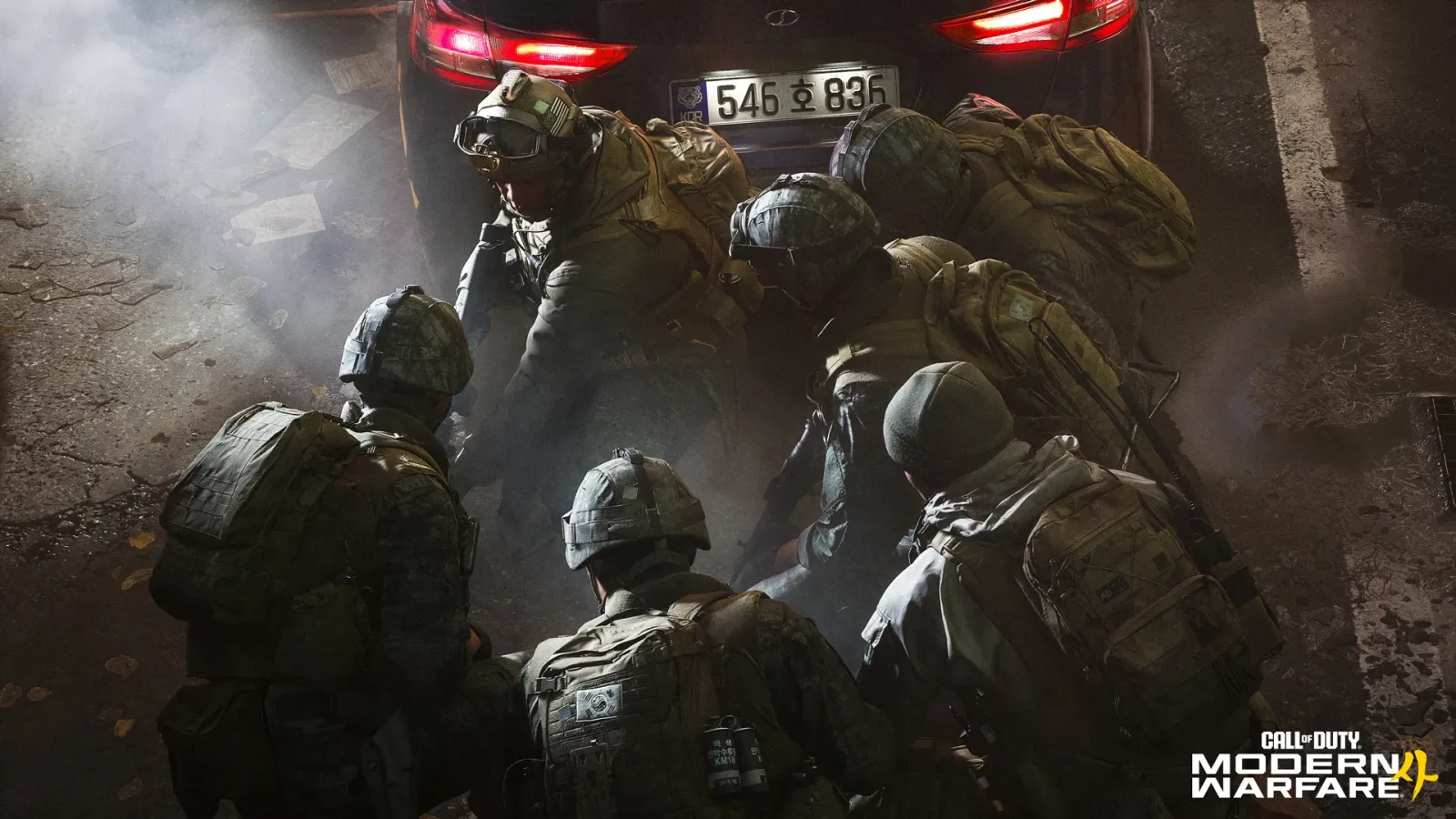 South Korean soldiers in camouflage crouching behind a car with a Korean licence plate in a smoky street
